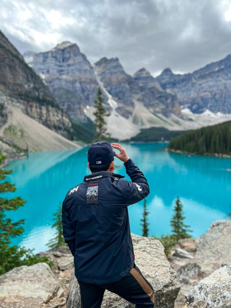 Traveler looking over Moraine Lake and the Valley of the Ten Peaks in Banff National Park.
